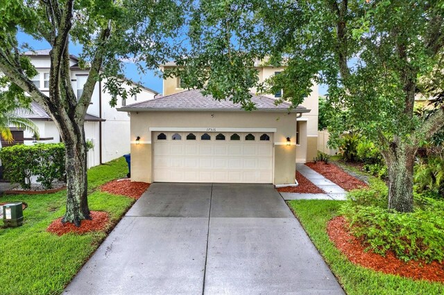 view of front of house with a garage and a front yard