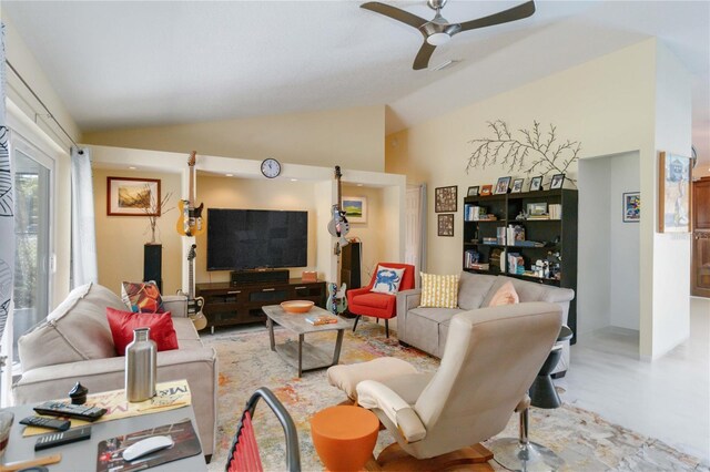 living room with ceiling fan and vaulted ceiling