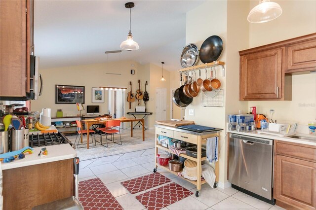 kitchen featuring dishwasher, light tile patterned floors, hanging light fixtures, and vaulted ceiling