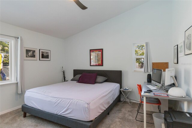 bedroom with carpet flooring, vaulted ceiling, and ceiling fan