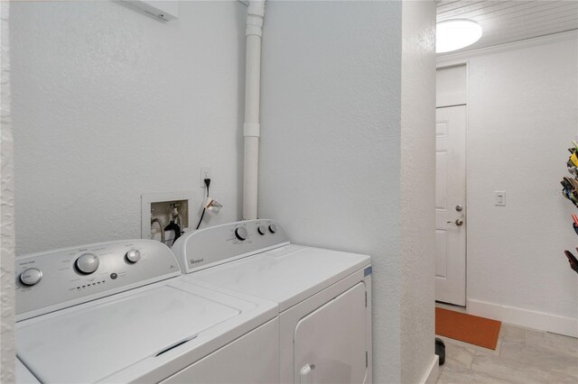 clothes washing area with washer and clothes dryer