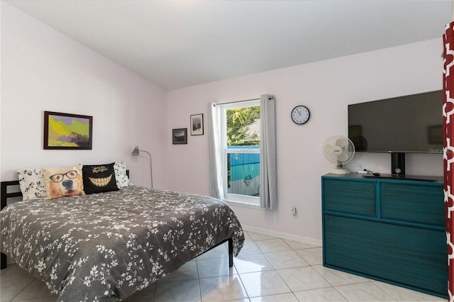 bedroom featuring light tile patterned floors and lofted ceiling