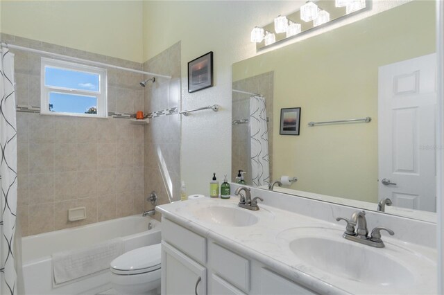 full bathroom with vanity, toilet, and shower / bath combo with shower curtain