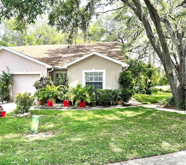 35226 Janine Dr, Zephyrhills, FL 33541 - ranch-style house featuring a garage, stucco siding, a front yard, and a shingled roof