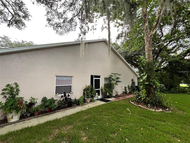 35226 Janine Dr, Zephyrhills, FL 33541 - view of home's exterior with stucco siding and a yard