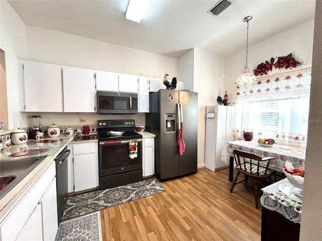 35226 Janine Dr, Zephyrhills, FL 33541 - kitchen featuring appliances with stainless steel finishes, light wood-type flooring, white cabinetry, and a chandelier