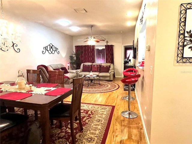 35226 Janine Dr, Zephyrhills, FL 33541 - dining space featuring wood finished floors, a ceiling fan, and a chandelier