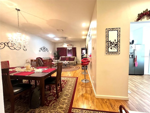35226 Janine Dr, Zephyrhills, FL 33541 - dining room with wood finished floors and a chandelier