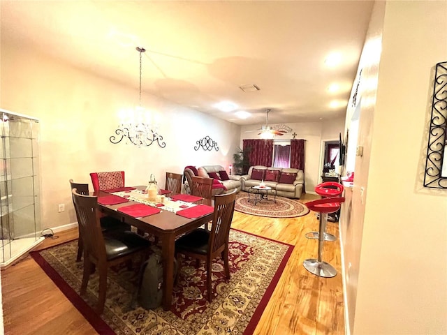 35226 Janine Dr, Zephyrhills, FL 33541 - dining space with wood finished floors and a chandelier