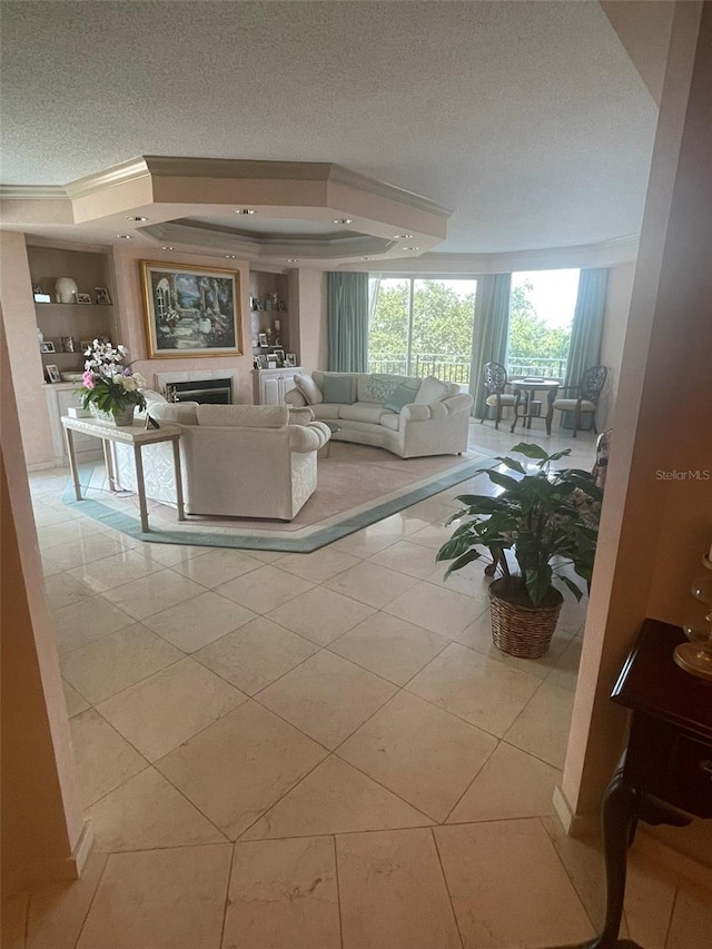 tiled living room featuring a textured ceiling and a tray ceiling