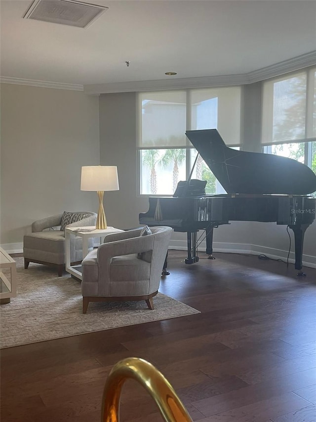 living room with plenty of natural light, dark hardwood / wood-style floors, and ornamental molding