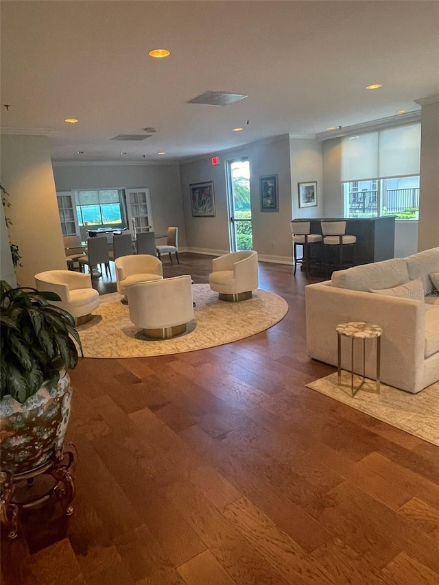 living room with hardwood / wood-style flooring and ornamental molding