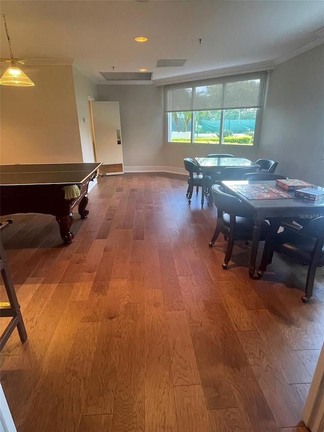 dining room with hardwood / wood-style floors and ornamental molding