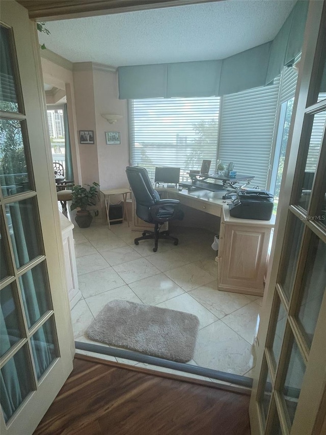 office with plenty of natural light and a textured ceiling