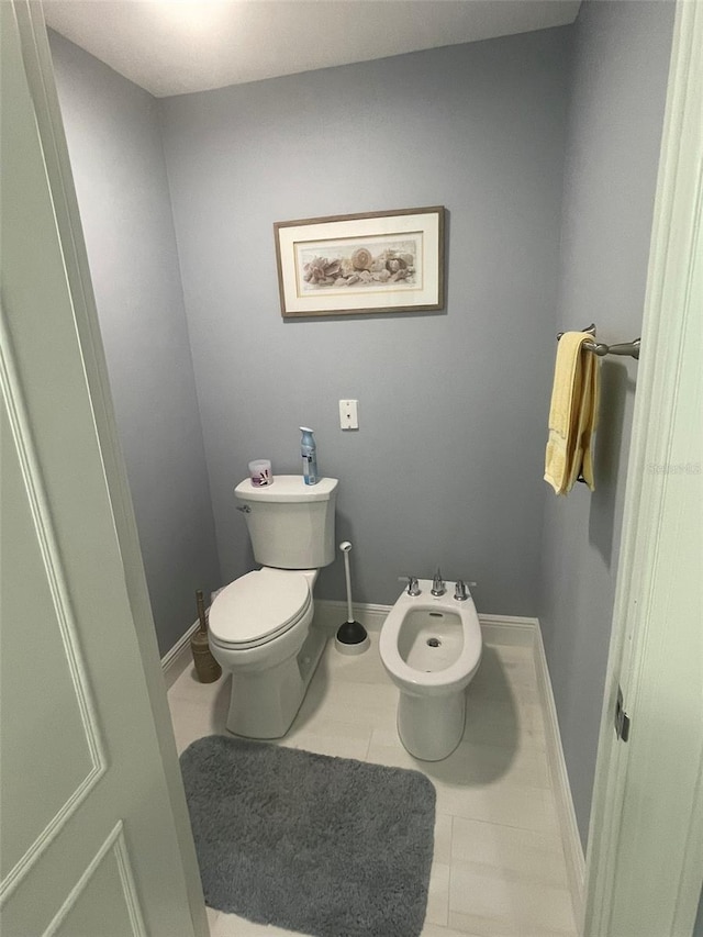 bathroom featuring a bidet, tile patterned floors, and toilet