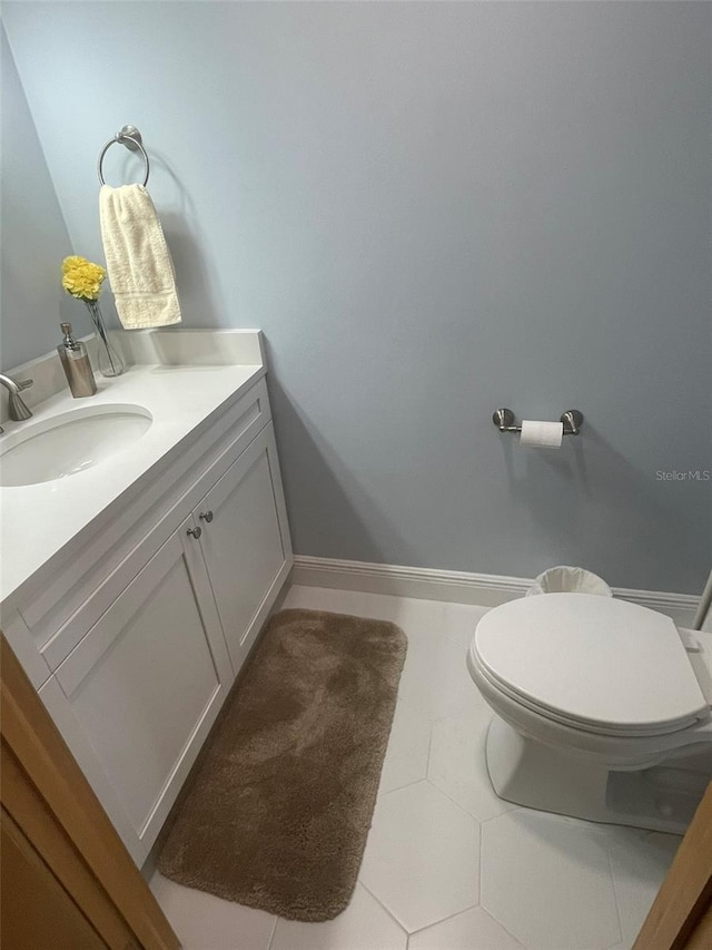 bathroom featuring vanity, toilet, and tile patterned flooring