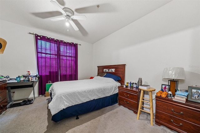 carpeted bedroom with ceiling fan and vaulted ceiling