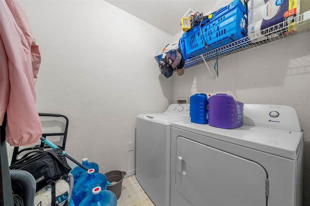 clothes washing area with separate washer and dryer