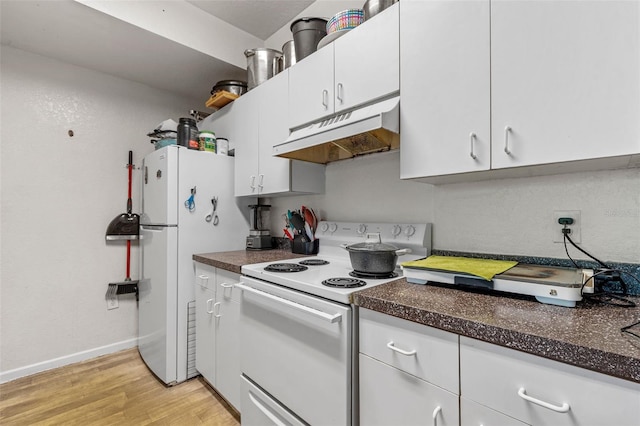 kitchen with white appliances, white cabinets, and light hardwood / wood-style flooring