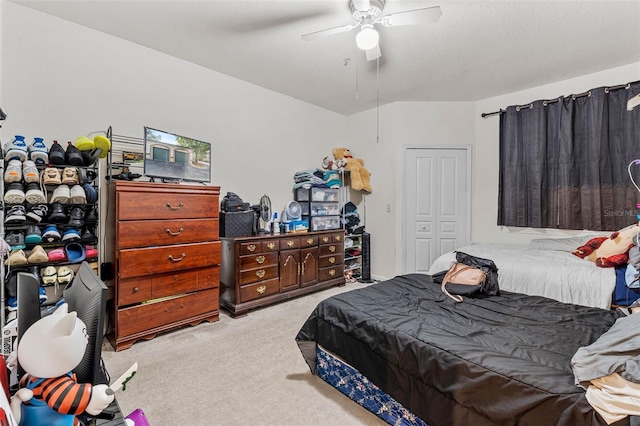 carpeted bedroom with ceiling fan and a closet