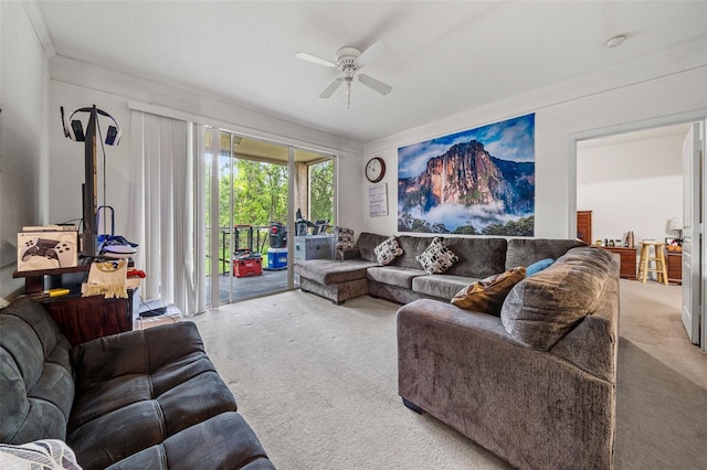 carpeted living room featuring ceiling fan and crown molding