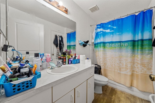 full bathroom with toilet, shower / bathtub combination with curtain, and vanity