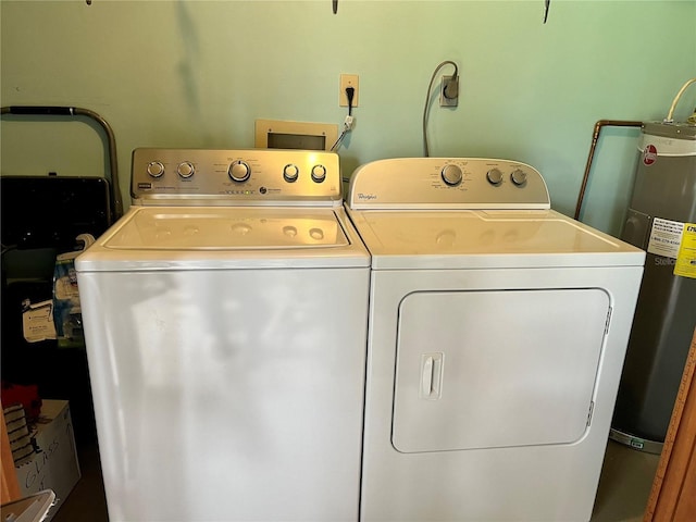 clothes washing area with separate washer and dryer and electric water heater