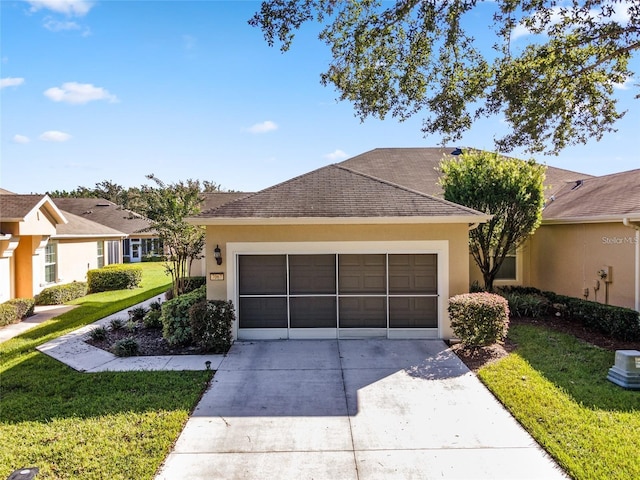 ranch-style home with a garage and a front lawn