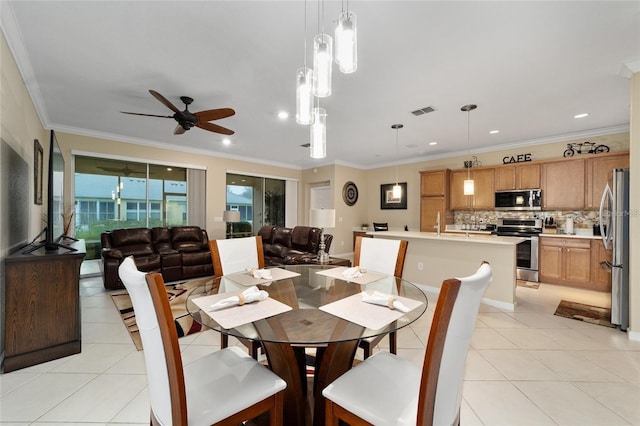 tiled dining area with ceiling fan and crown molding