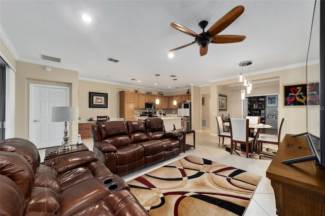 living room with ceiling fan, light tile patterned floors, and crown molding