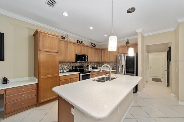 kitchen with sink, hanging light fixtures, stainless steel appliances, backsplash, and a kitchen island with sink