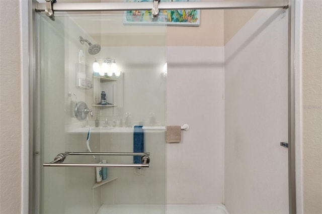 bathroom featuring a shower with door