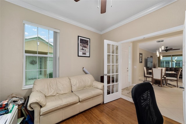 living room featuring french doors, hardwood / wood-style flooring, and crown molding