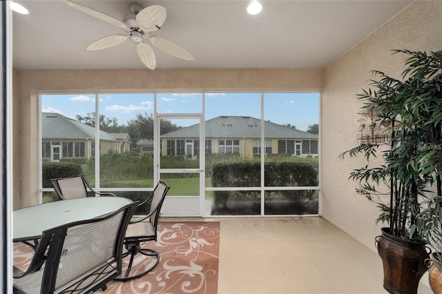 sunroom / solarium with ceiling fan and a healthy amount of sunlight