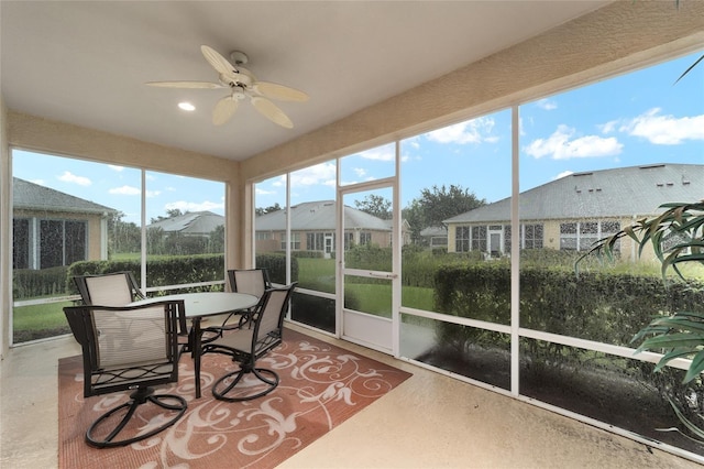 sunroom featuring ceiling fan