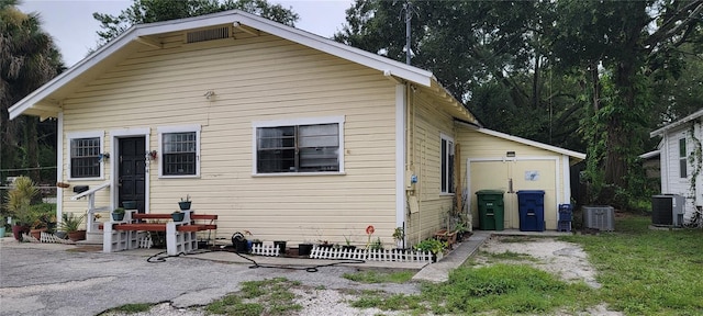 rear view of house featuring cooling unit and a patio