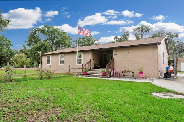 rear view of house featuring a lawn