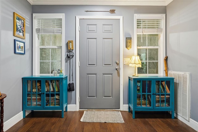 interior space featuring dark hardwood / wood-style floors and crown molding