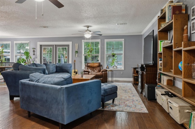 living room with dark hardwood / wood-style floors, ceiling fan, and crown molding