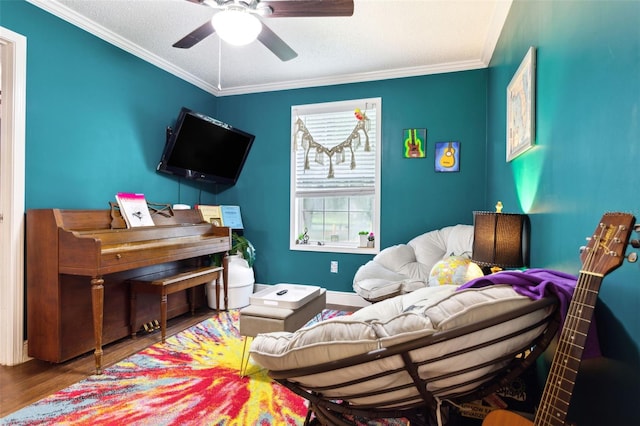 interior space featuring wood-type flooring, a textured ceiling, ceiling fan, and ornamental molding