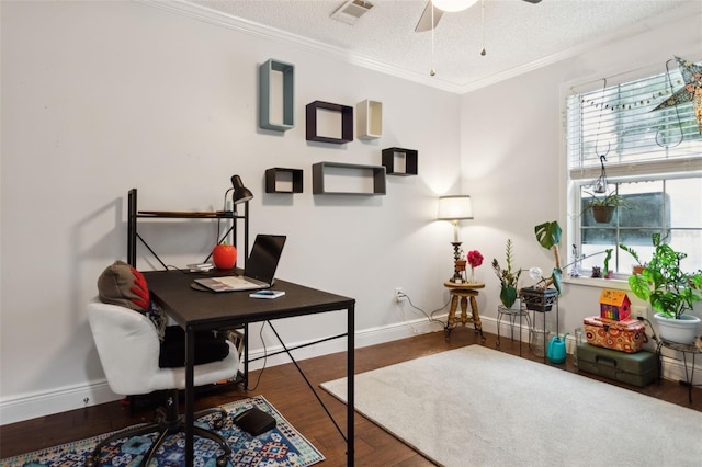 home office with ceiling fan, dark hardwood / wood-style flooring, a textured ceiling, and ornamental molding