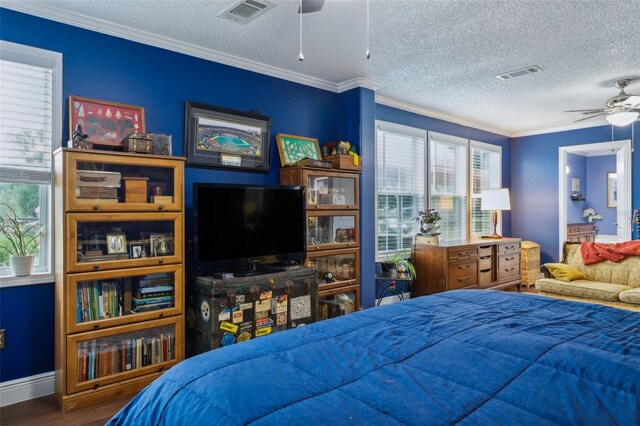 bedroom with ceiling fan, hardwood / wood-style floors, and ornamental molding