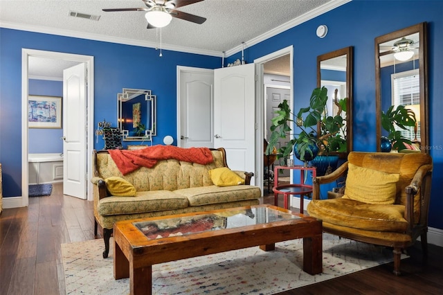 living area with ceiling fan, wood-type flooring, ornamental molding, and a textured ceiling