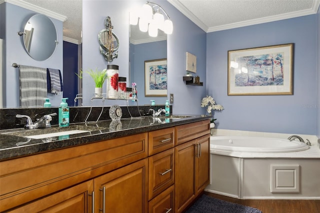 bathroom featuring vanity, a bathing tub, crown molding, a textured ceiling, and wood-type flooring