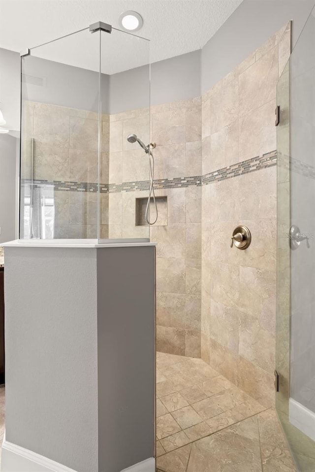 bathroom with tiled shower