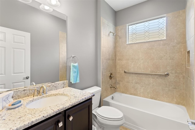 full bathroom featuring vanity, toilet, and tiled shower / bath