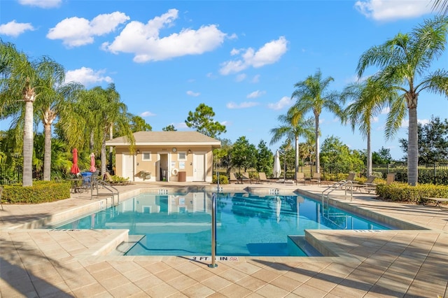 view of pool with a patio area and an outdoor structure