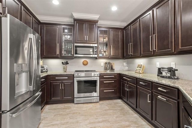 kitchen with crown molding, dark brown cabinets, and appliances with stainless steel finishes