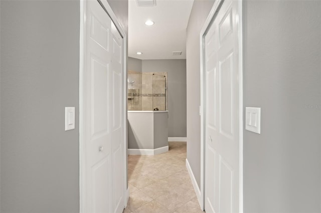 hallway featuring light tile patterned floors