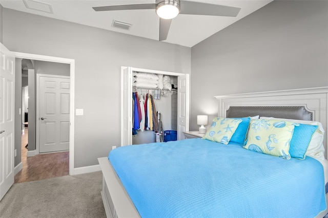 bedroom featuring ceiling fan, a closet, carpet floors, and vaulted ceiling